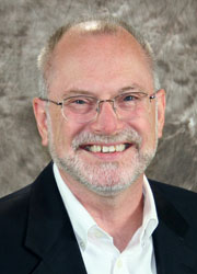 Head shot of Craig Svensson, a white male with glasses, smiling for the camera.